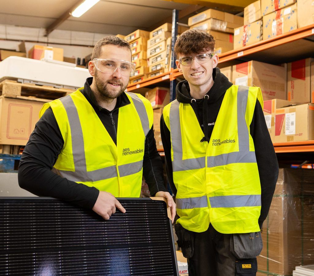 Two men in high vis and safety goggle stand around a solar panel as part of being a Scottish Apprenticeship Awards Finalist 2026